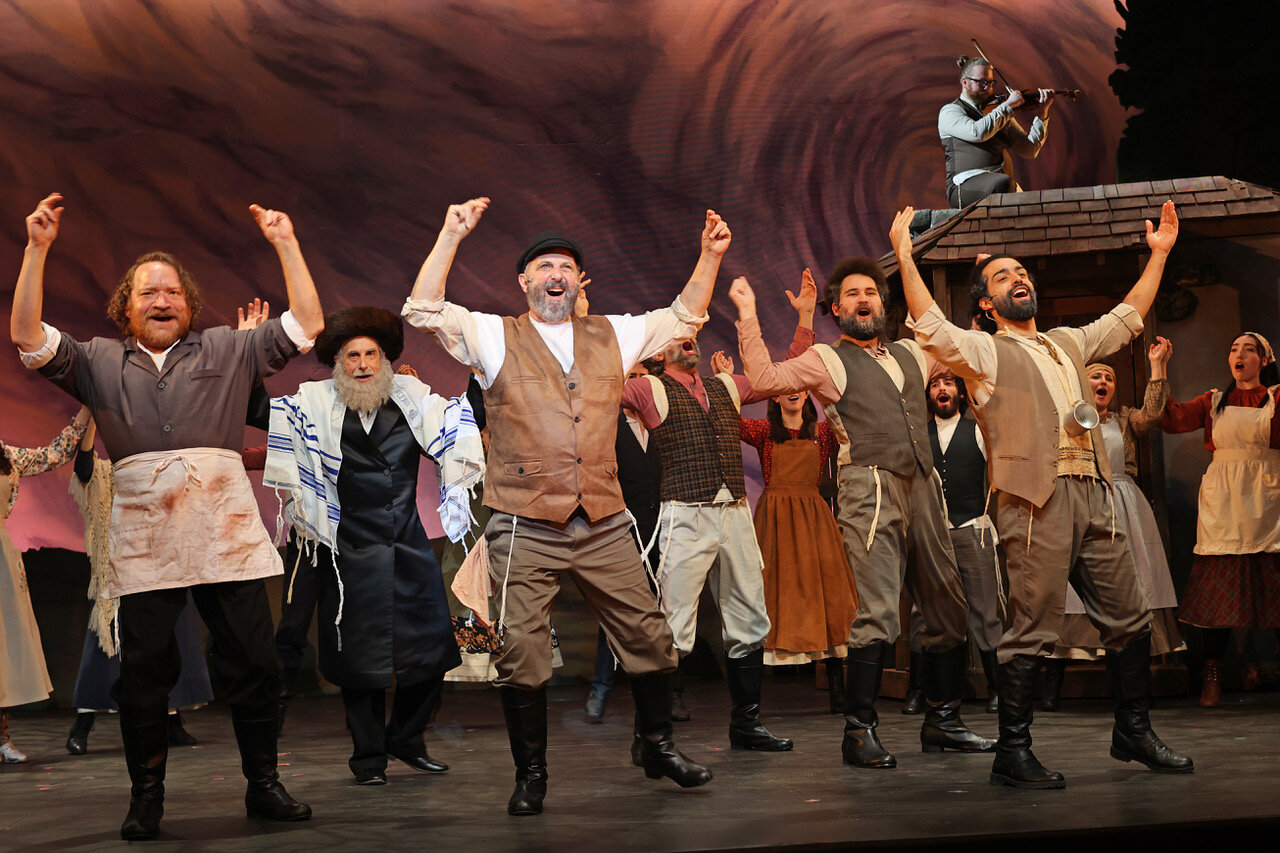 “Fiddler on the Roof,” cast members in the front row (left to right): Justin R. Holcomb (Lazar Wolf), Bruce Winant (Tevye), Ben Cherry (Mordcha), Jose Contreras (Nachum) with the actual Fiddler (Samuel Gray).